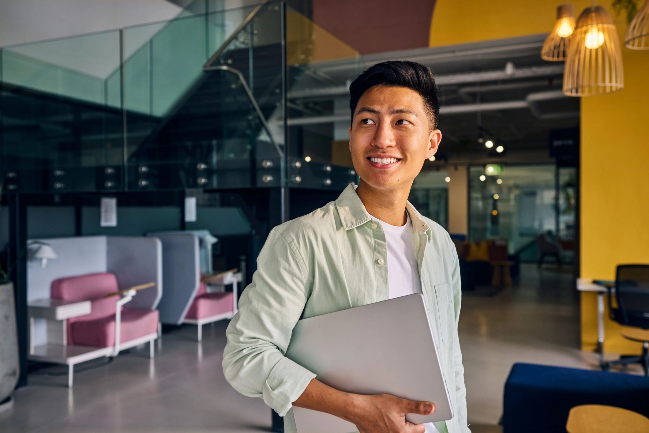 IT professional holding a laptop in an office
