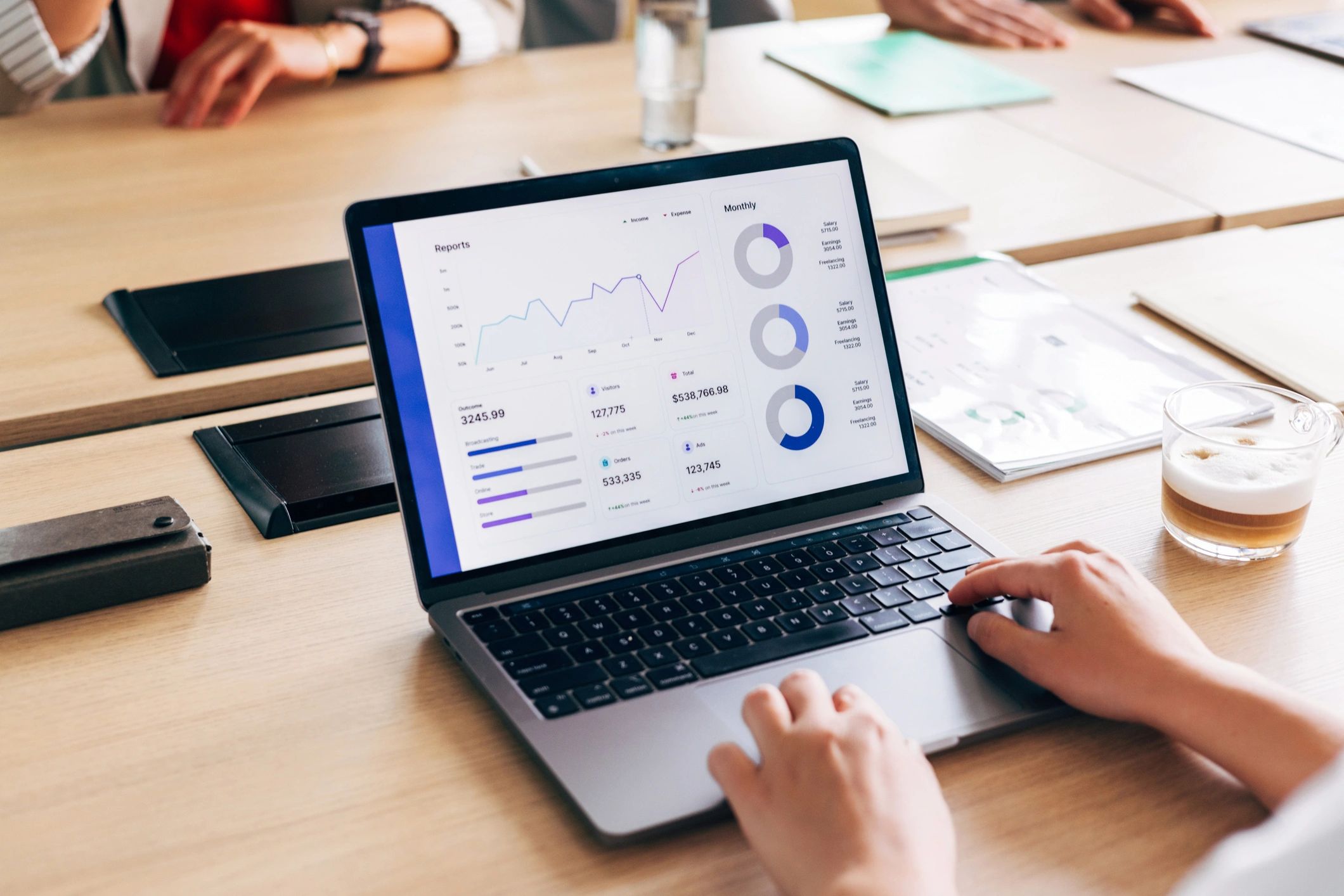 Professional analyzing data on a laptop during a meeting